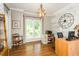 Bright home office with hardwood floors, white brick wall, and decorative lighting at 5601 Jomali Dr, Durham, NC 27705