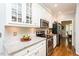 Bright kitchen with white cabinetry, stainless steel appliances, and beautiful countertops at 5601 Jomali Dr, Durham, NC 27705