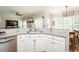 Bright kitchen with stainless dishwasher, sink, granite countertop, and open to living area at 5601 Jomali Dr, Durham, NC 27705