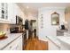 Open kitchen with granite countertops, stainless appliances, and hardwood floors at 5601 Jomali Dr, Durham, NC 27705