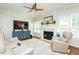 Inviting living room featuring a fireplace, TV, ceiling fan, and comfortable seating area at 5601 Jomali Dr, Durham, NC 27705