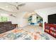 Bright playroom with built-in shelving and storage, a comfortable sofa, and a ceiling fan at 5601 Jomali Dr, Durham, NC 27705