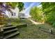 The backyard has stairs, a deck, and plenty of green space for activities at 5865 Forest Point Rd Rd, Raleigh, NC 27610