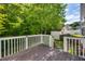 Wooden backyard deck overlooking a green backyard with a shed at 5865 Forest Point Rd Rd, Raleigh, NC 27610