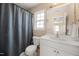 Well-lit bathroom featuring a vanity, window, and tiled floor at 5865 Forest Point Rd Rd, Raleigh, NC 27610
