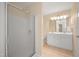 Bathroom with a shower and a double sink vanity with white cabinetry and neutral walls at 5865 Forest Point Rd Rd, Raleigh, NC 27610