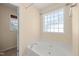 Relaxing bathroom with a jetted tub under a privacy window at 5865 Forest Point Rd Rd, Raleigh, NC 27610