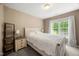 Cozy bedroom with a queen bed and a window with natural light at 5865 Forest Point Rd Rd, Raleigh, NC 27610