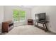 Minimalist bedroom with neutral carpet, featuring a window and two side tables at 5865 Forest Point Rd Rd, Raleigh, NC 27610