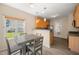 Eat-in kitchen dining area featuring a gray table set and a window overlooking the backyard at 5865 Forest Point Rd Rd, Raleigh, NC 27610