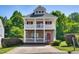 Charming two-story home boasts dual porches, stone accents, and mature landscaping at 5865 Forest Point Rd Rd, Raleigh, NC 27610