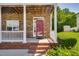 Inviting front porch with classic white columns and stone accents at 5865 Forest Point Rd Rd, Raleigh, NC 27610
