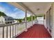 Inviting front porch with painted red floors and white railings, offering a lovely neighborhood view at 5865 Forest Point Rd Rd, Raleigh, NC 27610