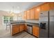 Modern kitchen featuring stainless steel appliances, wood cabinets, a window, and an eat-in dining area at 5865 Forest Point Rd Rd, Raleigh, NC 27610