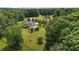 Private estate aerial showcasing lush landscaping and a serene, wooded backdrop at 60 Hartwood Ln, Youngsville, NC 27596