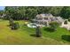 Expansive property featuring a stunning home, a sparkling pool area, and verdant lawns surrounded by mature trees at 60 Hartwood Ln, Youngsville, NC 27596