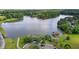 Stunning aerial view of lakeside estate featuring a private dock, mature trees, and well-manicured grounds at 60 Hartwood Ln, Youngsville, NC 27596