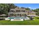 Stunning backyard with a large pool, outdoor seating, and a beautifully landscaped lawn for luxurious outdoor living at 60 Hartwood Ln, Youngsville, NC 27596