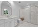 Bright bathroom with marble tile, white vanity, and glass-enclosed shower at 60 Hartwood Ln, Youngsville, NC 27596