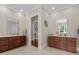 Bathroom with dual vanities, wood cabinetry, tile floors and lighting and hardware at 60 Hartwood Ln, Youngsville, NC 27596