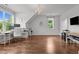 Bonus room with wood floors, two windows, and a desk area at 60 Hartwood Ln, Youngsville, NC 27596