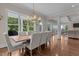 Elegant dining area featuring a large table, seating for eight, and large windows offering scenic views at 60 Hartwood Ln, Youngsville, NC 27596
