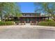 Exterior shot of building with a metal roof and a well-kept lawn, framed by large trees at 60 Hartwood Ln, Youngsville, NC 27596