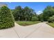 Beautifully landscaped front yard with mature trees and a circular driveway at 60 Hartwood Ln, Youngsville, NC 27596