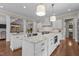 Spacious kitchen with white cabinetry, granite countertops, and two islands for ample workspace and seating at 60 Hartwood Ln, Youngsville, NC 27596