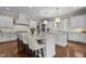 Bright kitchen featuring white cabinets, granite countertops, and an island with seating at 60 Hartwood Ln, Youngsville, NC 27596