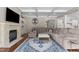 Comfortable living room features a stone fireplace, coffered ceilings, and a plush sectional sofa at 60 Hartwood Ln, Youngsville, NC 27596