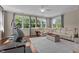 Spacious living room with large windows offering verdant views and a ceiling fan at 60 Hartwood Ln, Youngsville, NC 27596