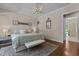Main bedroom featuring a neutral color palette, stylish light fixture, and ensuite bathroom at 60 Hartwood Ln, Youngsville, NC 27596