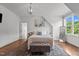 Bright bedroom featuring wood floors, rug, white walls, and an abundance of natural light at 60 Hartwood Ln, Youngsville, NC 27596