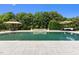 A beautiful pool featuring a small waterfall, surrounded by a stone patio, and seating areas at 60 Hartwood Ln, Youngsville, NC 27596
