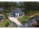 Aerial view of a home with a circular driveway and manicured lawn at 604 Dappled Pine Ave, Durham, NC 27713