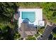 Aerial view of community pool and spa with surrounding greenery and clubhouse at 604 Dappled Pine Ave, Durham, NC 27713