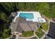 Aerial view of community pool, clubhouse, and spa with ample parking and mature trees at 604 Dappled Pine Ave, Durham, NC 27713