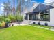 Backyard view of a luxurious home with a covered patio at 604 Dappled Pine Ave, Durham, NC 27713