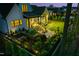 Aerial view of a landscaped backyard with stone accents, an outdoor seating area and lush green lawn at 604 Dappled Pine Ave, Durham, NC 27713