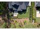Aerial view of a landscaped backyard with a seating area, beautiful foliage and trees at 604 Dappled Pine Ave, Durham, NC 27713