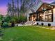 Picturesque backyard with a well-maintained lawn, stone patio and natural stone walkway at 604 Dappled Pine Ave, Durham, NC 27713