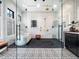 This luxurious bathroom features a glass-enclosed shower and standalone tub at 604 Dappled Pine Ave, Durham, NC 27713