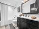 Modern bathroom with subway tile shower, black vanity and contemporary fixtures at 604 Dappled Pine Ave, Durham, NC 27713