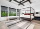 This bedroom boasts a canopy bed, a stylish ceiling fan, and light-colored wood floors at 604 Dappled Pine Ave, Durham, NC 27713