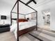 This primary bedroom offers a four-poster bed and designer touches at 604 Dappled Pine Ave, Durham, NC 27713