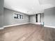 Large, versatile bonus room with light gray walls and hardwood floors at 604 Dappled Pine Ave, Durham, NC 27713
