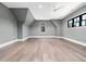 Spacious bonus room featuring hardwood floors, natural light, and fresh gray paint at 604 Dappled Pine Ave, Durham, NC 27713