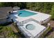 Community pool with hot tub, spacious deck, and clubhouse offering luxurious amenities at 604 Dappled Pine Ave, Durham, NC 27713