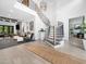 Open entryway with a winding staircase and modern chandelier, flowing into the spacious living area at 604 Dappled Pine Ave, Durham, NC 27713
